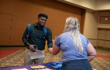 Student shaking hands with recruiter at job fair